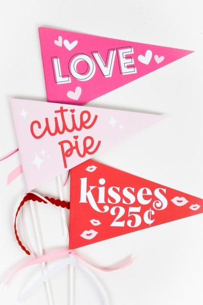 Three printable valentine's day pennants on white table
